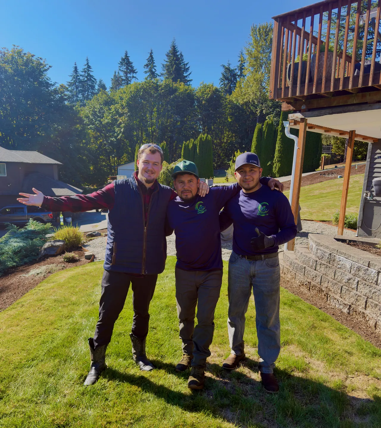 Cory, Tino and Angel, the Cactus LLC crew, on a client lawn below the deck