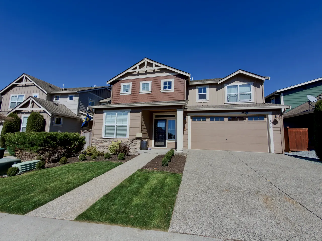 Craftsman house frontage with lawn and concrete drive