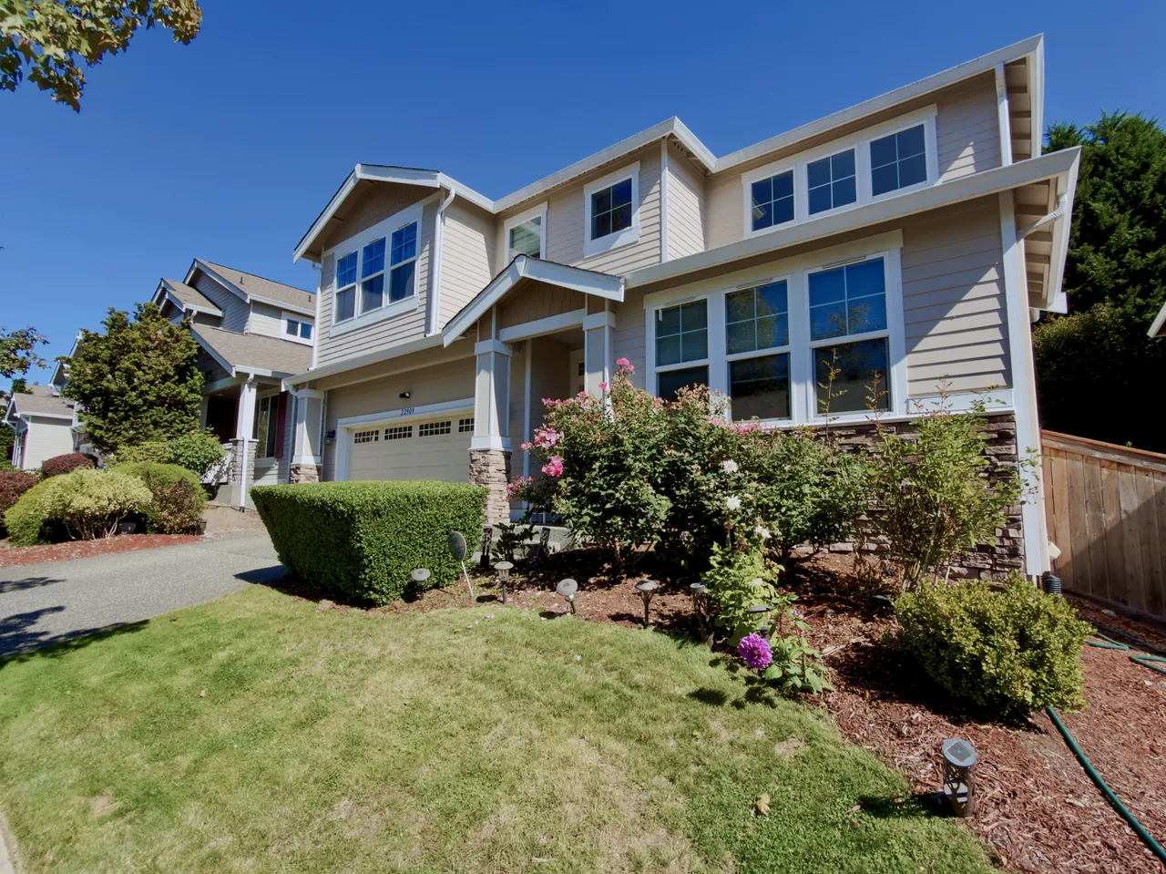 Front lawn and foundation beds of a two story house