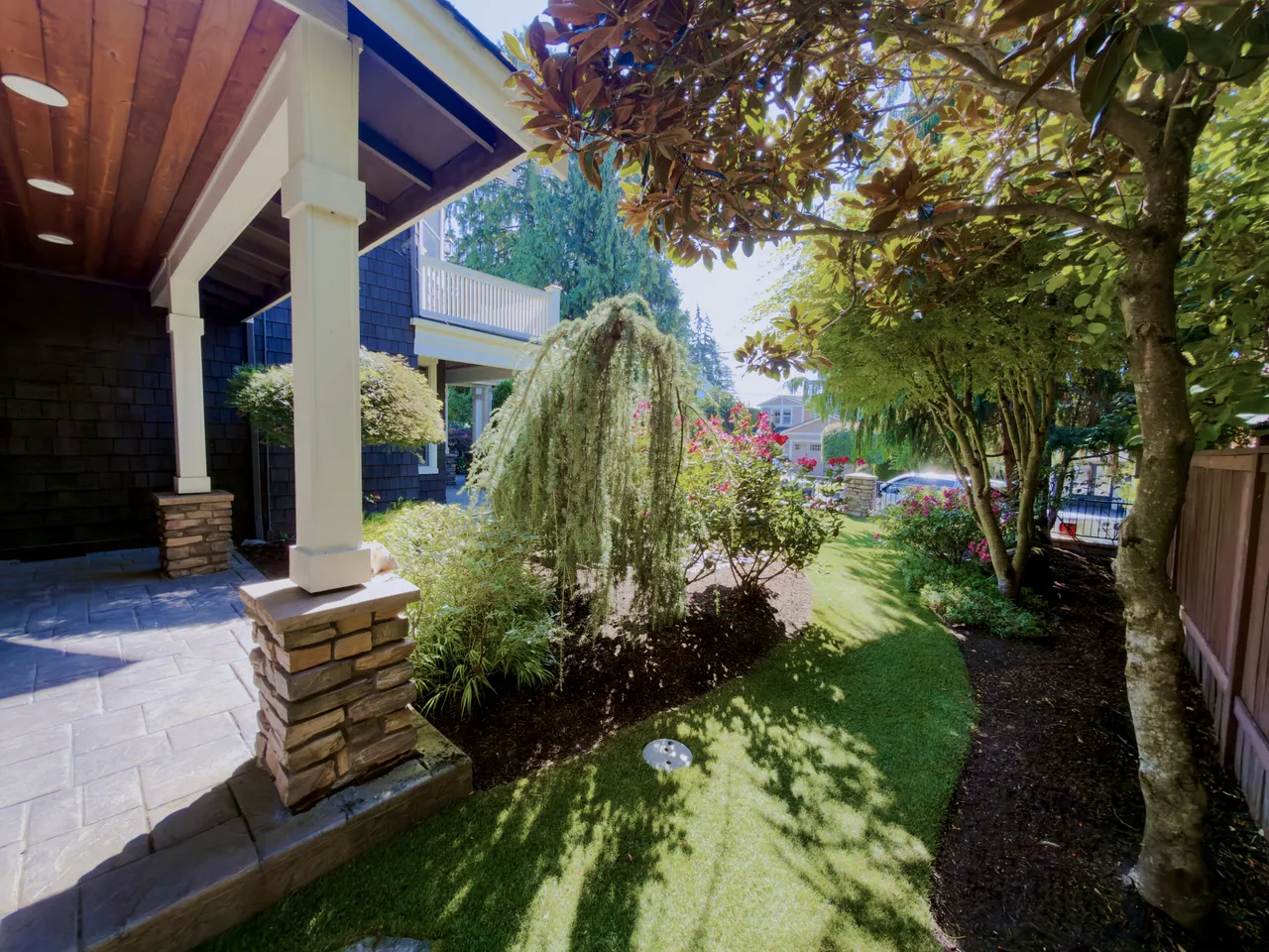 Craftsman porch with stone pillars and a weeping Japanese maple