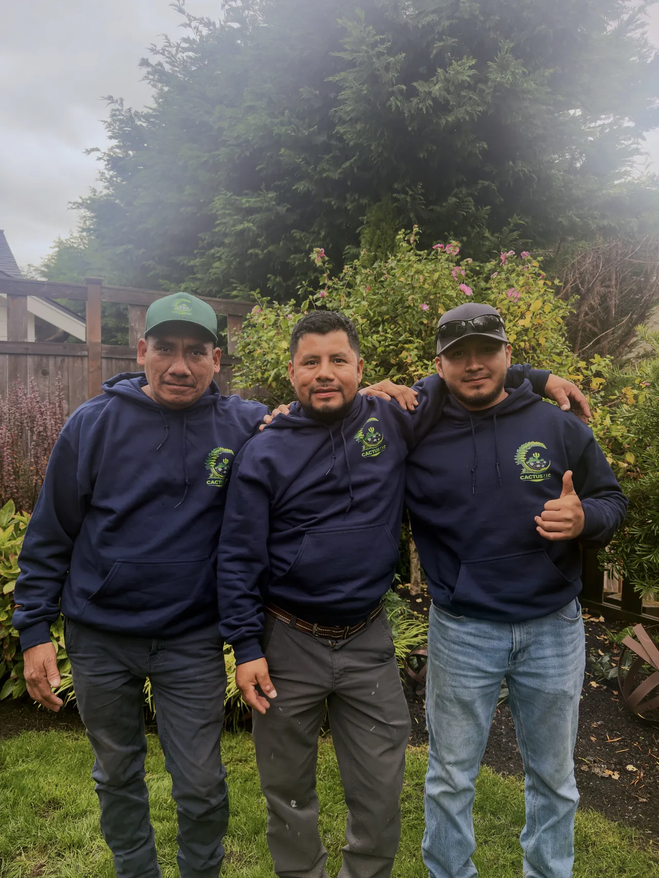Three crew members on an overcast morning