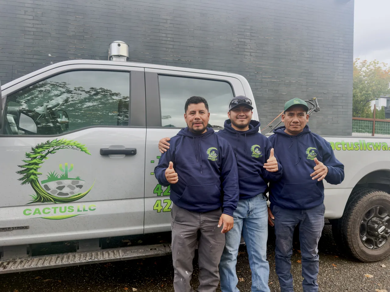 Three crew members beside the Cactus LLC truck